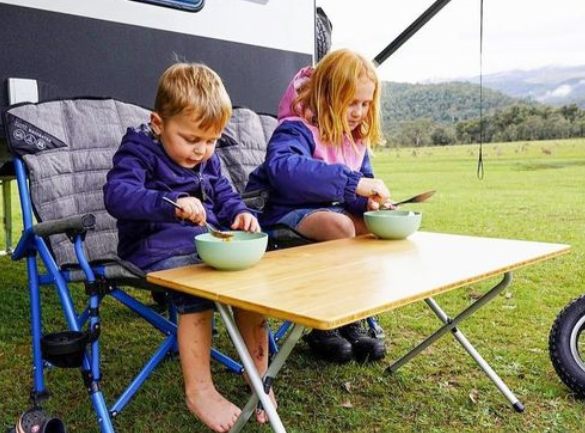 Kids eating from sustainable camping dinnerware.